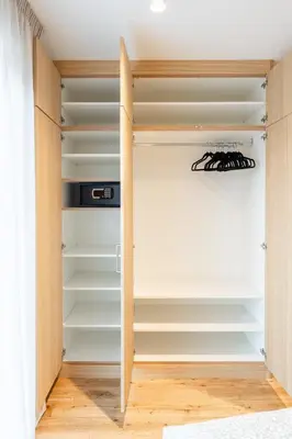 a walk in closet with white shelves at Villa Julia in Lana