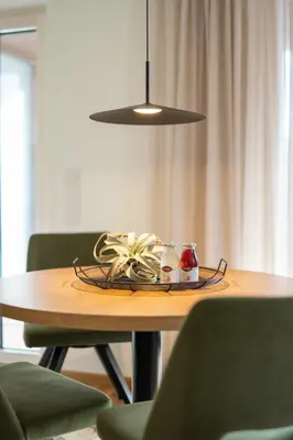a table with a plate of food and a lamp at Villa Julia in Lana