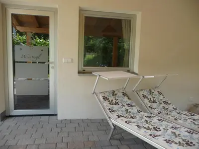 a porch with a bench in front of a door at Ferienwohnungen HÖLLERHOF in Terlan in Vilpiano
