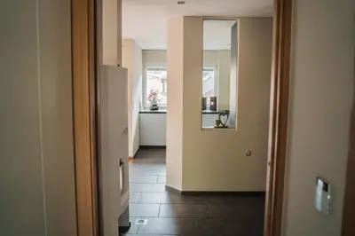 a hallway with a kitchen and a hallway with a hallway at Penthouse Ferienwohnung- 3 Schlafzimmer in Naturno
