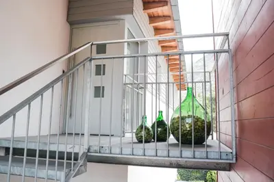 three green glass bottles sitting on a balcony at Penthouse Ferienwohnung- 3 Schlafzimmer in Naturno