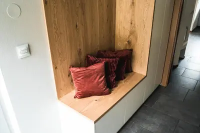 a shelf with three red pillows on it at Penthouse Ferienwohnung- 3 Schlafzimmer in Naturno