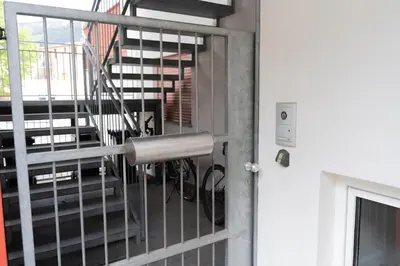 a door with a metal gate with a staircase at Penthouse Ferienwohnung- 3 Schlafzimmer in Naturno