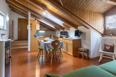 a kitchen and dining room with a table and chairs at DolomiApartments - Appartamento Fiordaliso in Predazzo