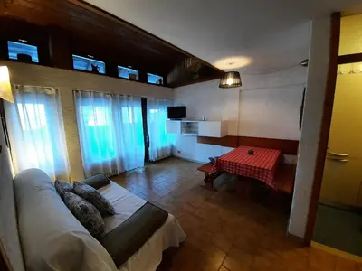 a living room with a couch and a table at Appartamento Fiorella in San Martino di Castrozza
