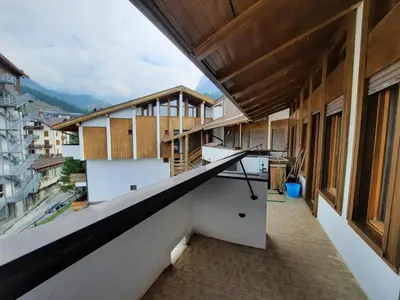 an empty balcony of a building with a stair case at Appartamento Fiorella in San Martino di Castrozza