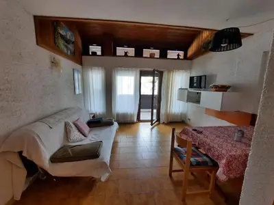 a living room with a couch and a table at Appartamento Fiorella in San Martino di Castrozza