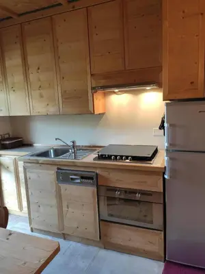 a kitchen with a sink and a stove top oven at Villa 5 Torri in Cortina dʼAmpezzo