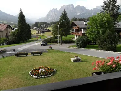 a park with a circle of flowers in the grass at Villa 5 Torri in Cortina dʼAmpezzo