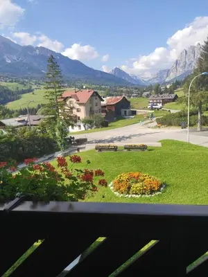 a view from a window of a park with flowers at Villa 5 Torri in Cortina dʼAmpezzo