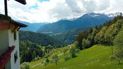 a view of a valley with mountains in the distance at Eggernhof in Lauregno