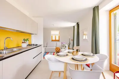 a kitchen and dining room with a table and chairs at Casa Pradiei Dolomiti View in Cavareno