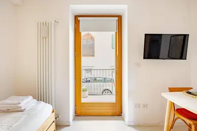 a room with a door leading to a balcony at Casa Pradiei Dolomiti View in Cavareno