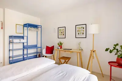 a bedroom with a bed and a desk and a table at Casa Pradiei Dolomiti View in Cavareno