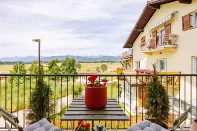 a balcony with a table with a flower pot on it at Casa Pradiei Dolomiti View in Cavareno