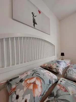 a bedroom with a bed and a painting on the wall at A casa di Cato in Merano