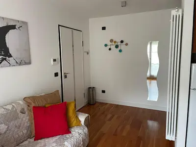 a living room with a couch and a mirror at A casa di Cato in Merano