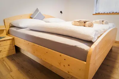 a wooden bed with towels on top of it at Oberkrösserhof in San Lorenzo di Sebato