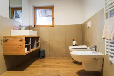 a bathroom with a toilet and a sink at Oberkrösserhof in San Lorenzo di Sebato