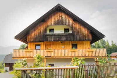 a house with a thatched roof and a fence at Oberkrösserhof in San Lorenzo di Sebato