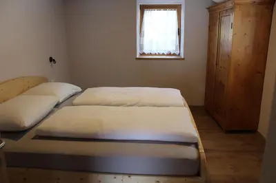 two twin beds in a room with a window at Oberkrösserhof in San Lorenzo di Sebato