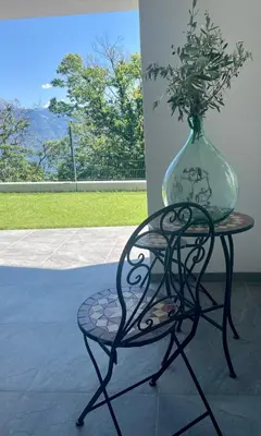 a vase on a table with a chair and a vase at Unterlechnerhof in Vollan