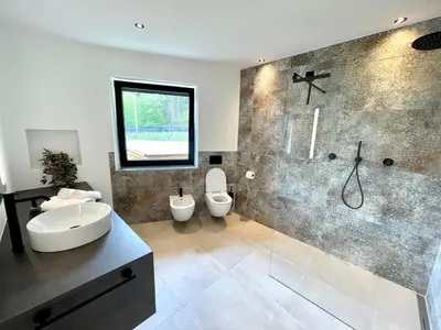 a bathroom with two toilets and a shower at Unterlechnerhof in Vollan