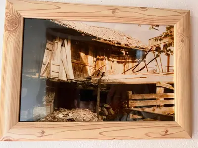 a picture of a building in a wooden picture frame at Ciasa AGB in Moena