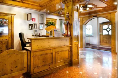 a barber shop with a wooden counter in a room at EL CIASEL in Canazei