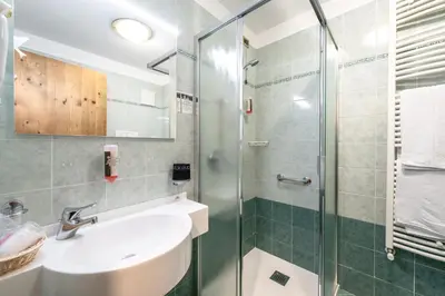 a bathroom with a sink and a shower at EL CIASEL in Canazei