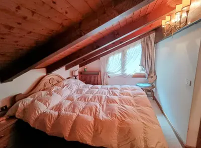 a bedroom with a large bed in a attic at San vito di Cadore centro - Cortina D'ampezzo in San Vito di Cadore