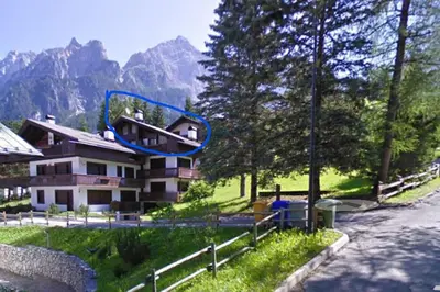 a house with a blue circle on the side of it at San vito di Cadore centro - Cortina D'ampezzo in San Vito di Cadore