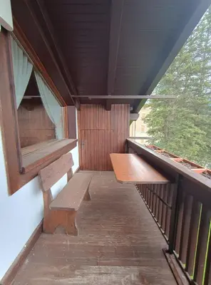 a porch with two benches in a train car at San vito di Cadore centro - Cortina D'ampezzo in San Vito di Cadore