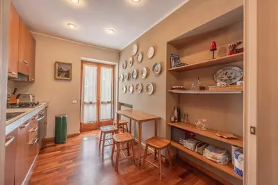 a kitchen with a table and chairs in a room at Casa Carina in Cortina d Ampezzo in Cortina dʼAmpezzo