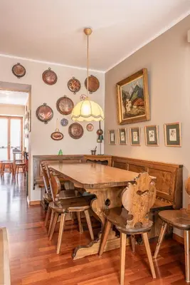 a dining room with a wooden table and chairs at Casa Carina in Cortina d Ampezzo in Cortina dʼAmpezzo