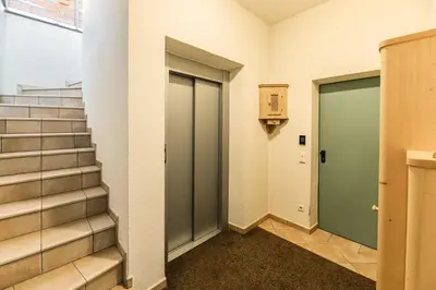 a hallway with stairs and doors in a building at Apartments Scherlin in Castelrotto