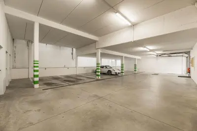 an empty parking garage with a car parked in it at Apartments Scherlin in Castelrotto