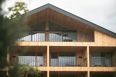 a timber building with a black roof at Gisse Zwölf in Gais