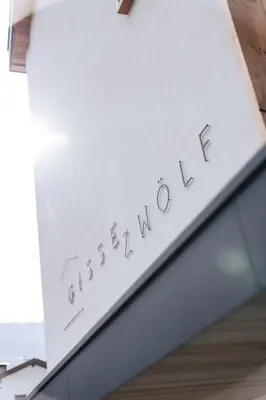 a sign that reads excellence on top of a building at Gisse Zwölf in Gais