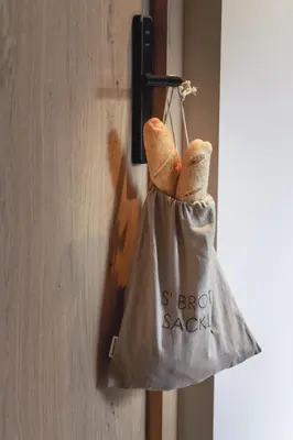 a bag of bread is hanging on a door at Gisse Zwölf in Gais