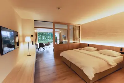 a bedroom with a large bed and a dining room at Gisse Zwölf in Gais