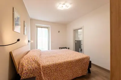 a bedroom with a bed and a window at Casa di Gio in Cavalese