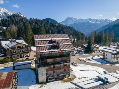 an aerial view of a building in the mountains at Appartamento Focobon in Falcade