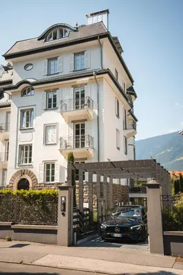 a black car parked in front of a building at Eden House Experience in Merano