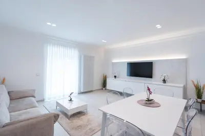 a living room with a couch and a tv at Eden House Experience in Merano