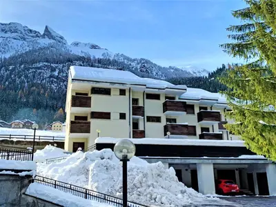 a building with snow in front of it at Apartment Mansarda Golfieri by Interhome in Alba di Canazei