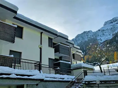 a building with snow on the balcony of it at Apartment Mansarda Golfieri by Interhome in Alba di Canazei