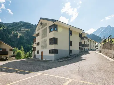 an empty parking lot in front of a building at Apartment Mansarda Golfieri by Interhome in Alba di Canazei
