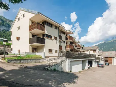 a apartment building with a balcony and a parking lot at Apartment Mansarda Golfieri by Interhome in Alba di Canazei