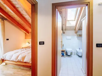 a bedroom with a bed and a bathroom at Apartment Condominio Parco degli abeti by Interhome in Canazei